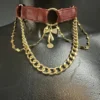 Berlin West burgundy leather choker with gold chains, ring pendant and bow charm