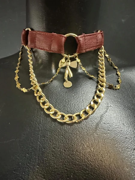 Berlin West burgundy leather choker with gold chains, ring pendant and bow charm