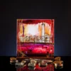 Small painted glass cube art piece with layered hand painted color, 16 by 16 cm