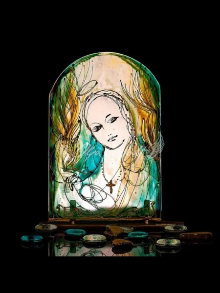 Hand painted glass icon of Our Lady with gentle expression and warm glow