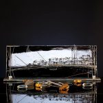 Noir Harbour hand painted glass panel with abstract harbour skyline in black and gold