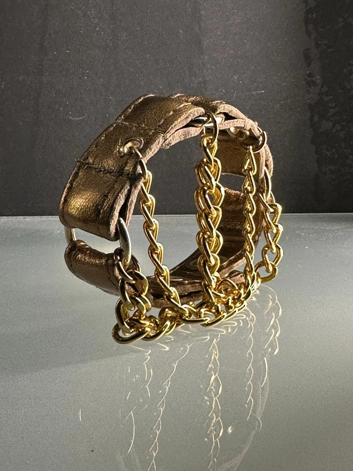 Metallic copper leather bracelet with gold hardware and draped chains – view 2