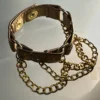 Metallic copper leather bracelet with gold hardware and draped chains