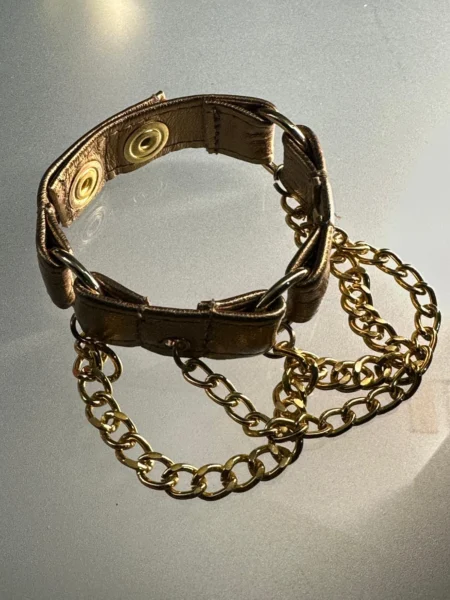 Metallic copper leather bracelet with gold hardware and draped chains