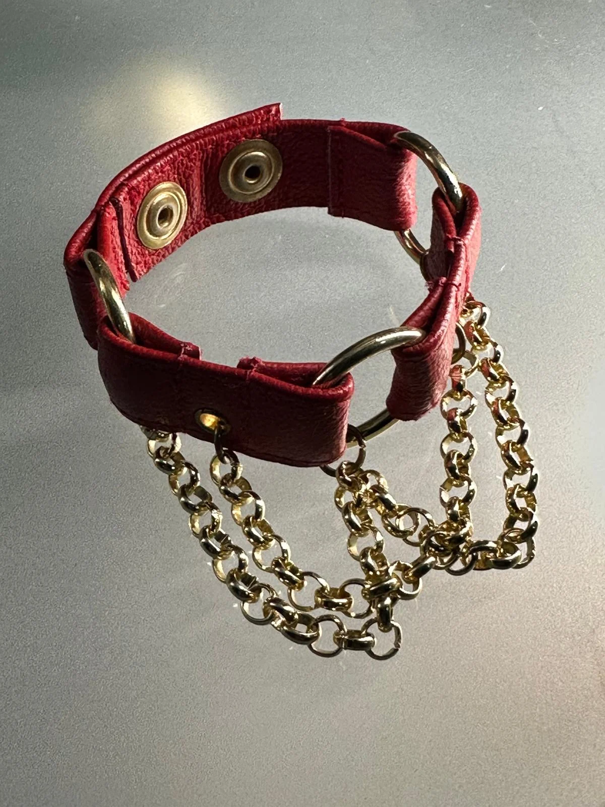 Crimson red leather chain bracelet with gold-tone chains and O-rings